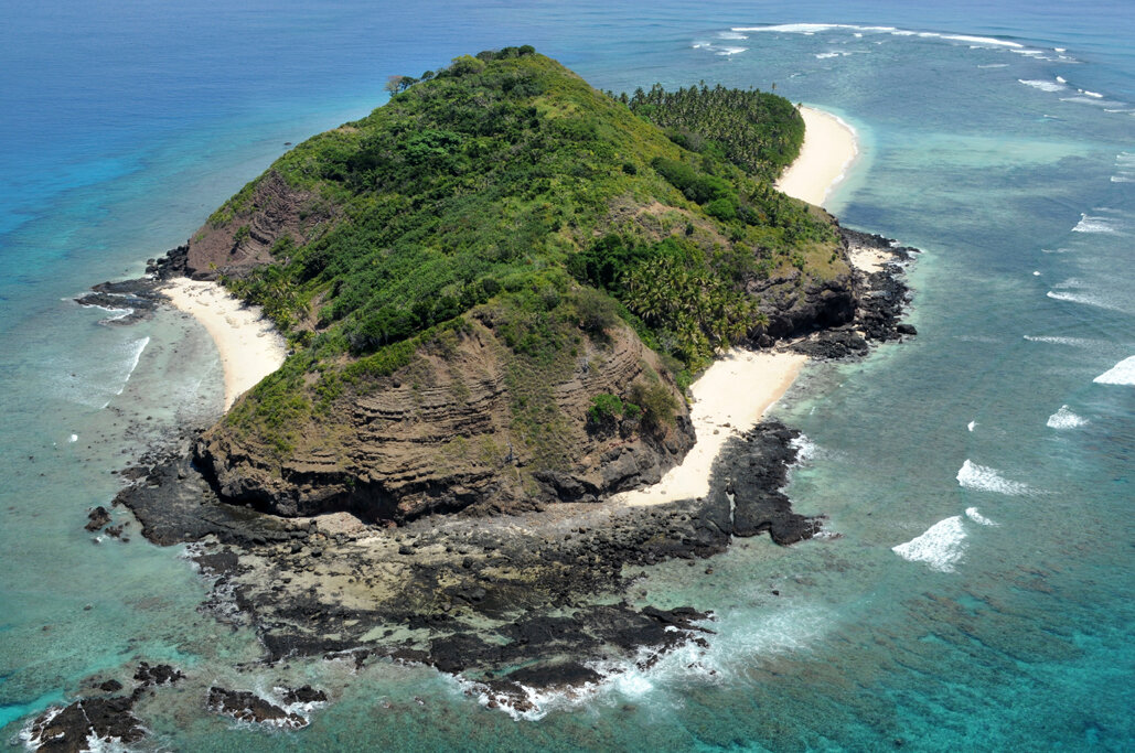 Angled aerial of Eori showing cliffs, coves, and reef edge